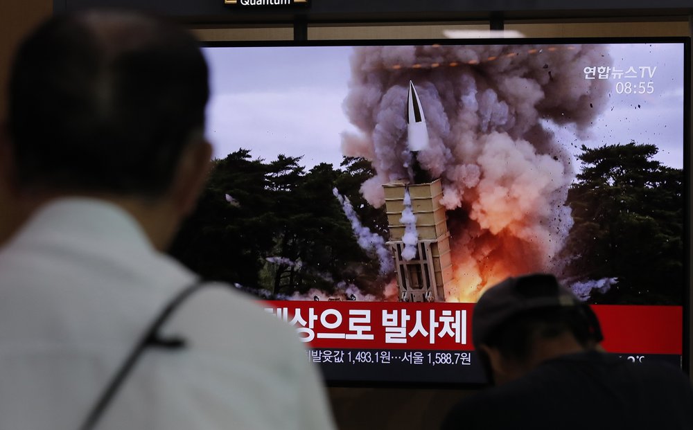 People watch a TV news program reporting North Korea's firing projectiles with a file image at the Seoul Railway Station in Seoul, South Korea, Saturday, Aug. 24, 2019. North Korea fired two suspected short-range ballistic missiles off its east coast on S